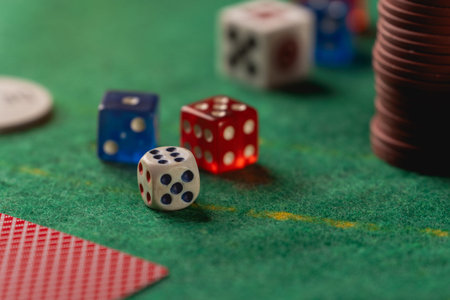 Colorful Dice on a Green Felt Table Surrounded by Poker Chips and Cards at a Casino Game Night...