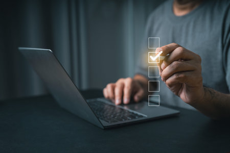 Close-up businessman hand User Interacting with Digital Checklist on Laptop Screen, Concept of Task...