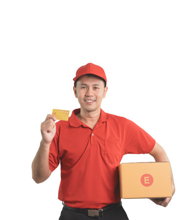 A cheerful delivery man in a red uniform poses with a package and payment card. He represents a...