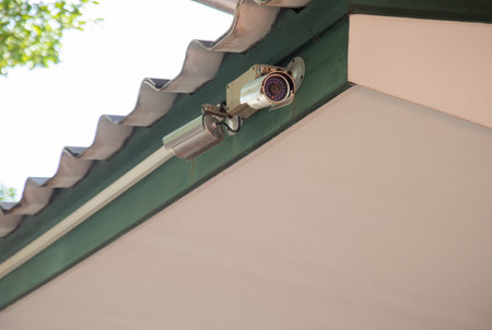 surveillance of cctv recording camera is installed at the roof of house overhead to watch, inspect...