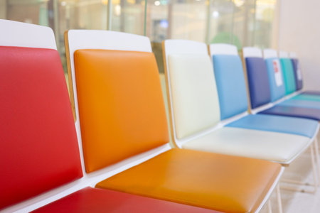 Selective focus shot with copy space of many colorful chairs in a row in the lobby or waiting room...