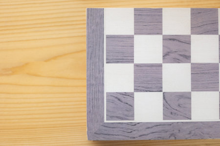 Top view or lay flat shot with copy space of vintage checkerboard shows beautiful pattern with wooden texture which is background on wooden table. It shows concept of both competition and recreation.の写真素材