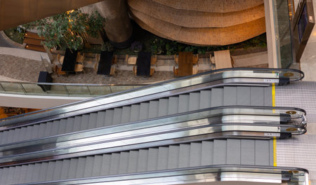 Top View and slow motion of two metal escalator is moving up and down to in department store or...