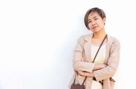 White background Portrait of beautiful and young asian woman with confident smile and posture shows concept of smart, attractive and positive business female with casual dress in modern lifestyle.の写真素材