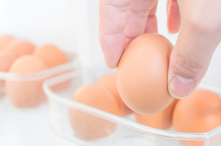 Taking out an egg from an egg tray