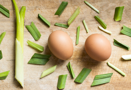 Onions and eggs on a wooden backgroundの写真素材