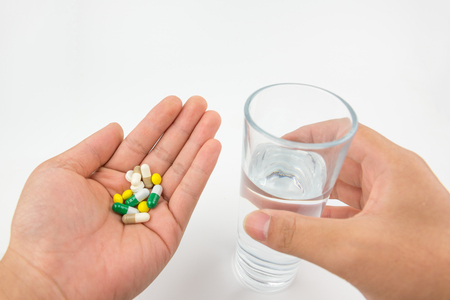 medicine pills with glass of waterの写真素材
