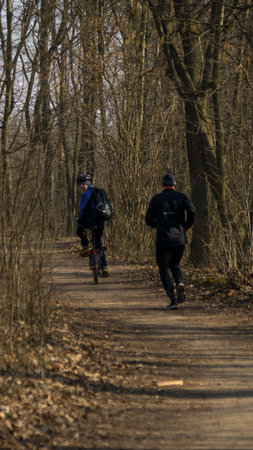 A cyclist pushes runner during the early spring training in the nature
