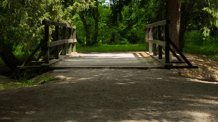 Wooden bridge over the stream in the parkの写真素材