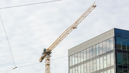 Crane working behind the office centerの写真素材
