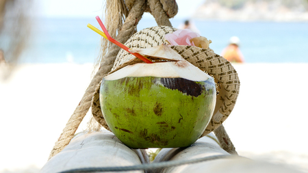 coconut on the swing at tropical beachの写真素材