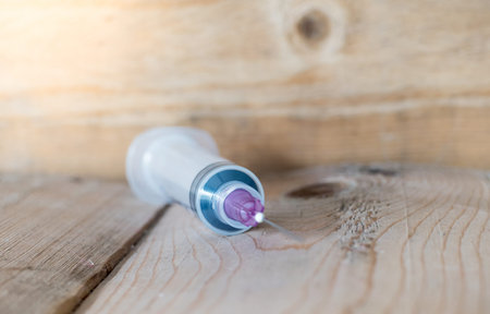 injection needle on the wooden table,Selected Focus