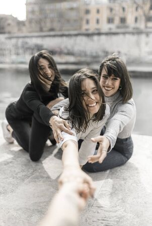 smiling girls cling to the photographerの写真素材
