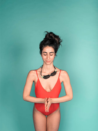 beautiful girl with red costume isolated on turquoise background