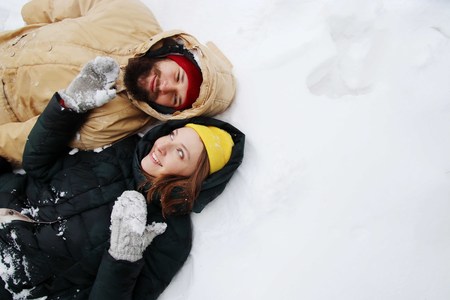 Happy couple in love having fun in the snow.の写真素材