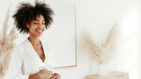 Pregnant woman with afro hairstyle smiling softly indoors, copy space, AI generatedの素材