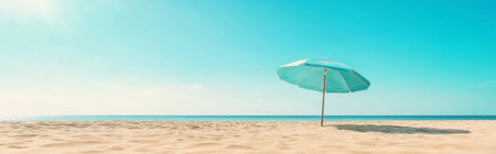 Beach umbrella on sandy beach under clear blue sky, summertime relaxation background, AI generatedの素材