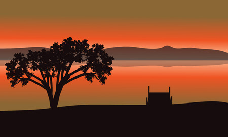 Single tree silhouette in lake with orrange backgroundsのイラスト素材