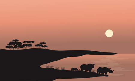 Two rhinoceros silhouette at the sunsetのイラスト素材