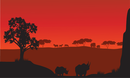 Silhouettes of african with rhino animals and red backgroundsのイラスト素材