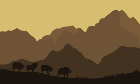 Silhouette of bull in mountain with brown backgroundsのイラスト素材