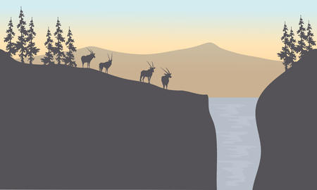 Silhouette of antelope in waterfall at sunsetのイラスト素材