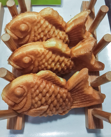 Fried fish with sweet stuffing in wooden shelf.の写真素材