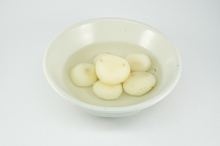 Peel raw chinese water chestnut in syrup on bowlの写真素材