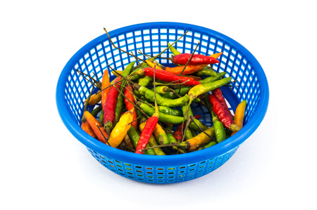 Chilli in blue basket, ,guinea-pepper isolated on white background with clipping pathの写真素材