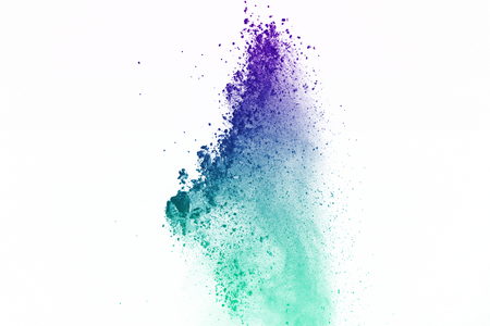 Freeze motion of colorful dust explosion on white background. Stop motion the movement of colorful powder on isolate background. Explosive of colorful cloud on white background.の写真素材
