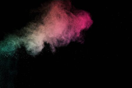 abstract colored dust explosion on a black background.abstract powder splatted background,Freeze motion of color powder exploding/throwing color powder, multicolored glitter texture.の写真素材