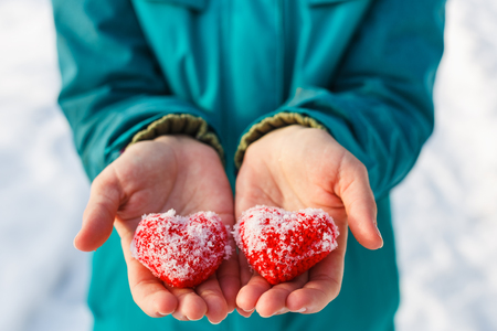 On the palms are two knitted hearts for Valentine's Dayの写真素材