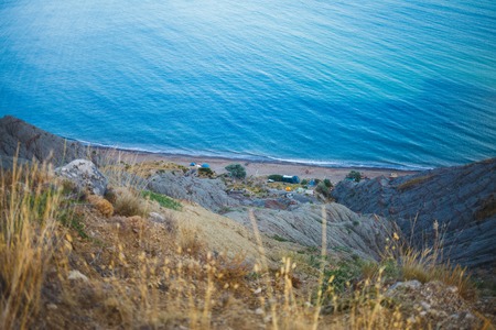 Wild sea bay with people and tentsの写真素材
