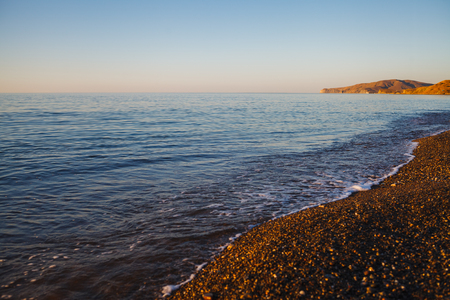 Sea shore from pebbles in the morningの写真素材