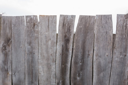 Texture of a gray curve fence from old boards.