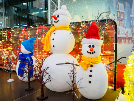 Three funny snowmen on stage at the mall.の写真素材
