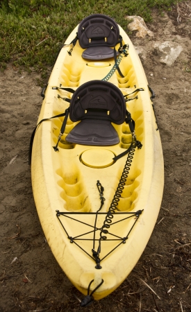 A lone sea kayak awaits visitors at Moss Landing in Californiaの写真素材