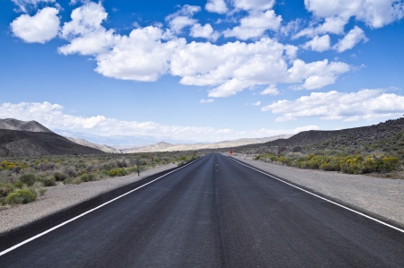 A vast expanse of open highway stretches across the Nevada desert north of Las Vegasの写真素材