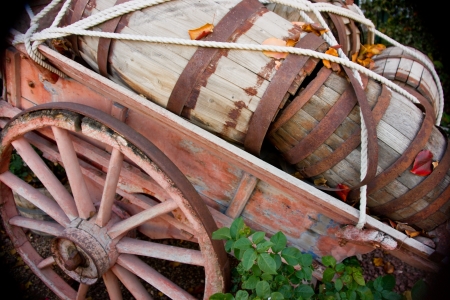 Old wooden kegs sit in an old woodnen wagon の写真素材