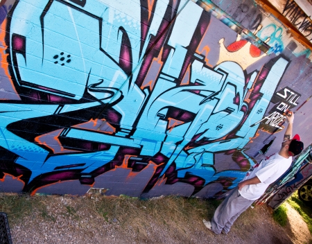 Las Vegas, Nevada - January 20, 2013  An anonymous artist paints a graffiti mural on the wall of a derelict building in downtown Las Vegas as part of the arts revival のeditorial素材