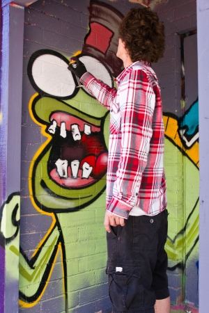 Las Vegas, Nevada - January 20, 2013  An anonymous artist paints a graffiti mural on the wall of a derelict building in downtown Las Vegas as part of the arts revival のeditorial素材