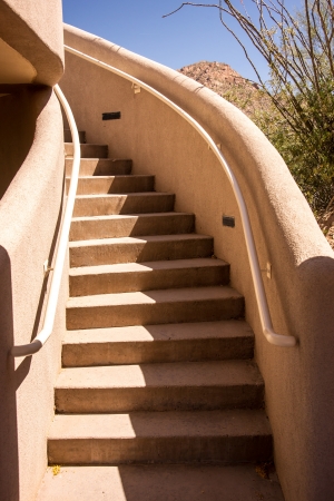 A curviliear stairway in a stucco building in the Arizona desertの写真素材