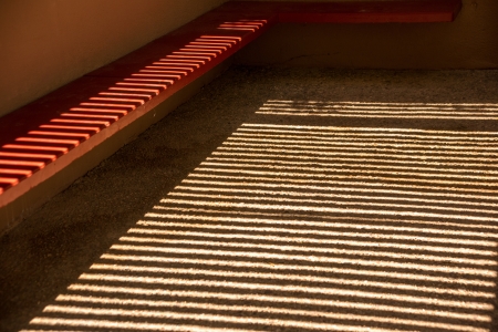 An abundance of shadows decorates the space beneath the ramada of a desert building in Arizona の写真素材