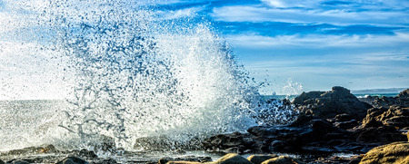 Close up of a wave crashing on the rocks of the Big Sur coast.の写真素材