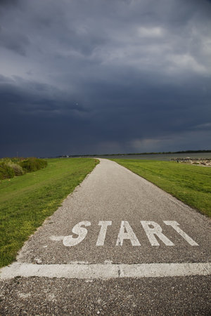 Asphalt road with Start inscription on bad weather 