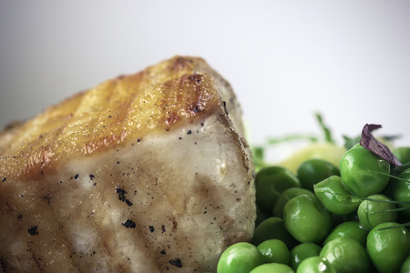 Grilled Butter fish steak with zucchini-pea stew braised in white wineの写真素材