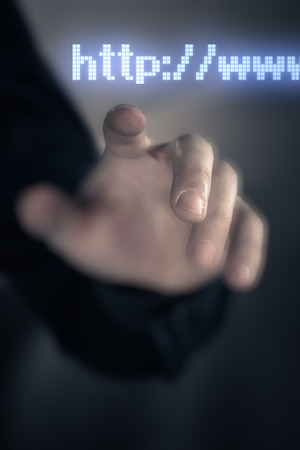 Touching hand futuristic screen internet conceptの写真素材