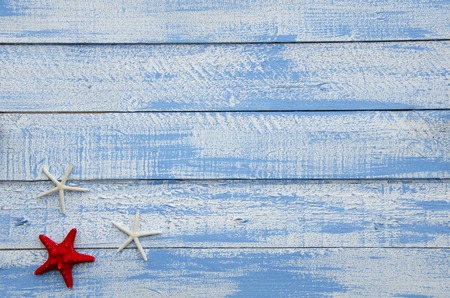 Seastars on a Shabby Chic Wood Rustic old plank background in turquoise, blue and white colors with textured scratches and antique cracked paintの写真素材