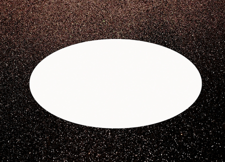 A shiny black background with a blank white oval for textの写真素材