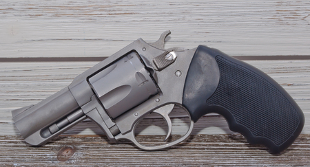 A stainless 44spl caliber revolver with a wooden backgroundの写真素材